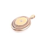 A late Victorian yellow gold locket, of stepped oval form, inset with an old round-cut diamond,