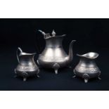 A Continental white metal three-piece teaset, comprising teapot, sugar bowl and creamer, with