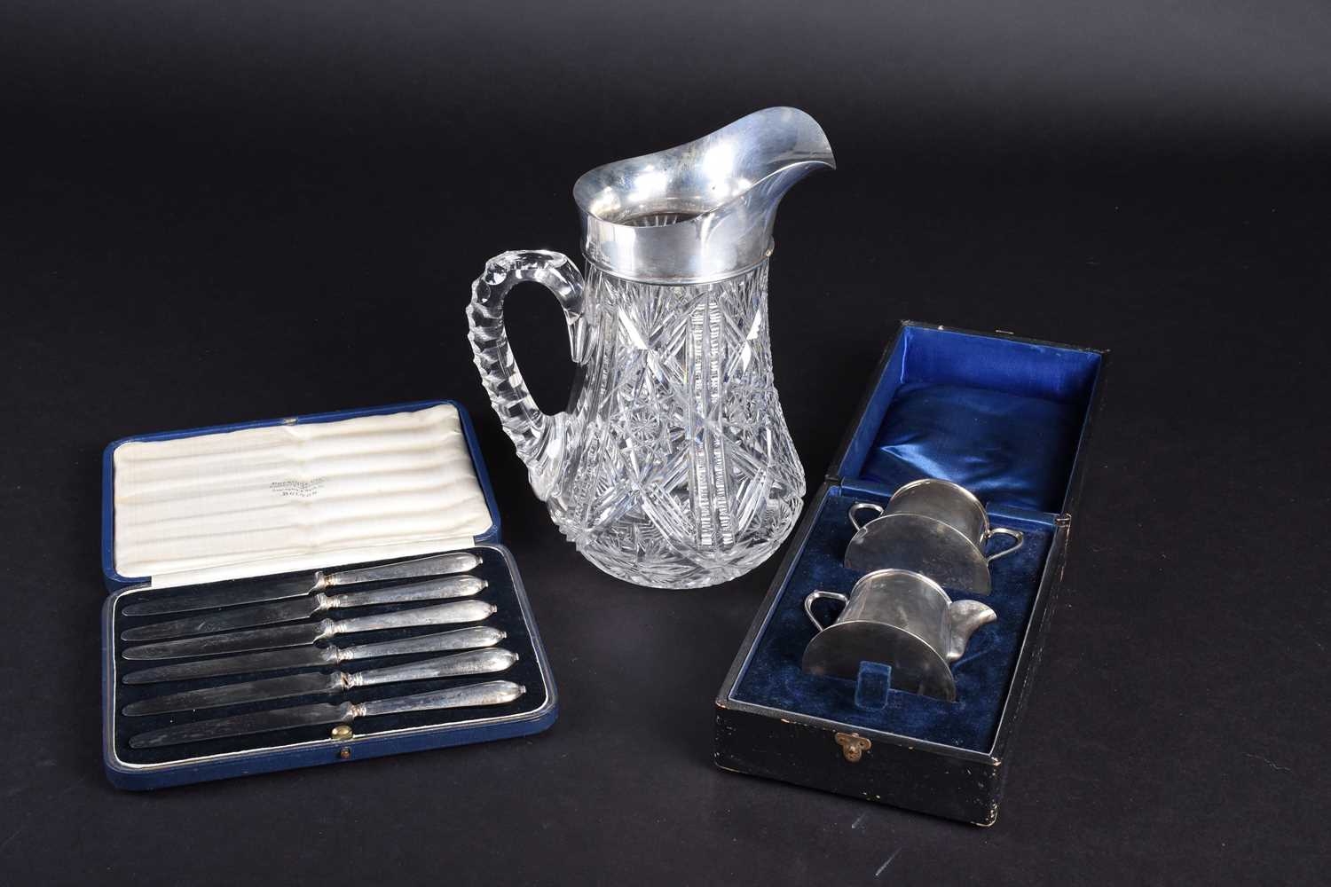 A silver mounted cut glass water pitcher, Birmingham 1938, together with a cased set of silver-