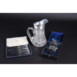 A silver mounted cut glass water pitcher, Birmingham 1938, together with a cased set of silver-