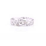 An 18ct white gold and diamond eternity ring, of stylised foliate design, millegrain decoration