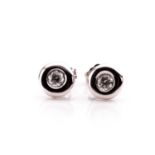 A pair of 18ct white gold and diamond ear studs, each rubover set with a round brilliant-cut diamond