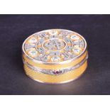 A Russian Faberge style 14ct gold circular box, set with diamonds and rubies flanking white enamel