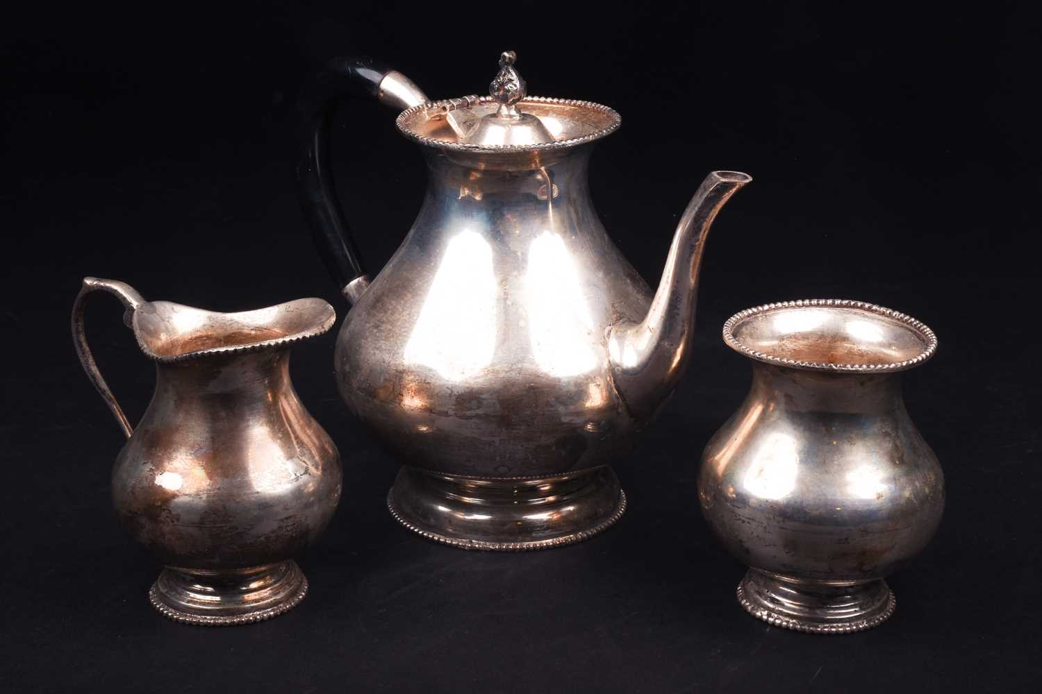 A Continental white metal three-piece teaset, marked 'Silver', comprising teapot, sucrier and