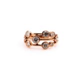 An 18ct rose gold and diamond ring, in the Boodles style, scatter-set with collet-mounted round