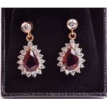 A pair of yellow metal, diamond, and garnet drop earrings, each set with a pear-cut garnet within