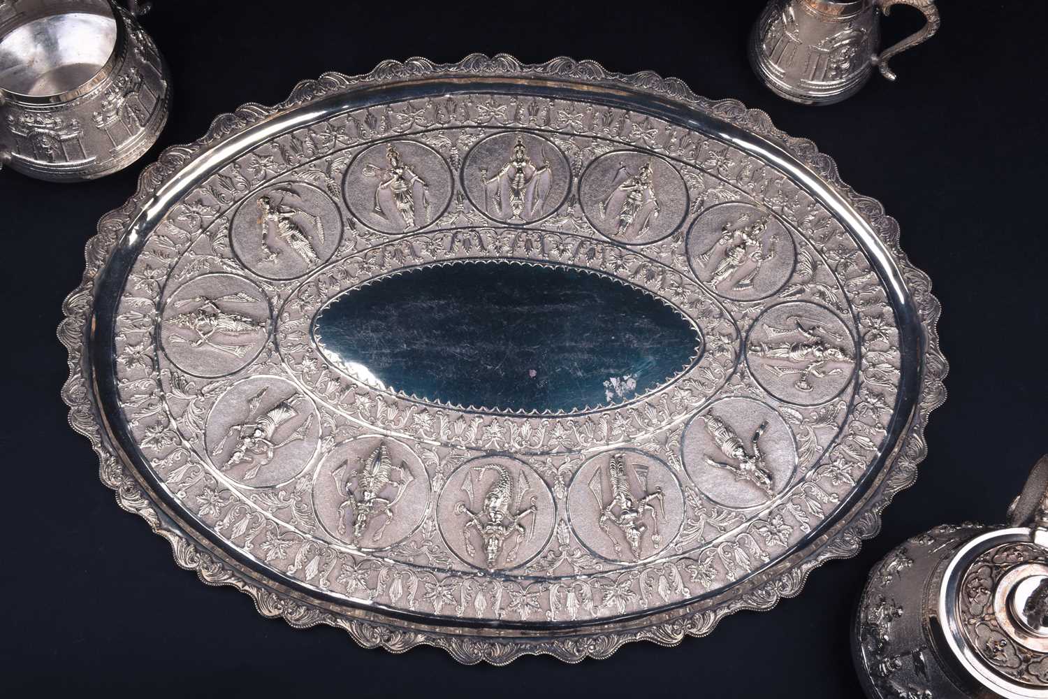 An Indian white metal three-piece teaset and conforming oval tray, 20th century, each decorated with - Image 4 of 5