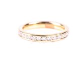 A full hoop diamond eternity ring, the round brilliant cut diamonds channel set in an 18ct gold