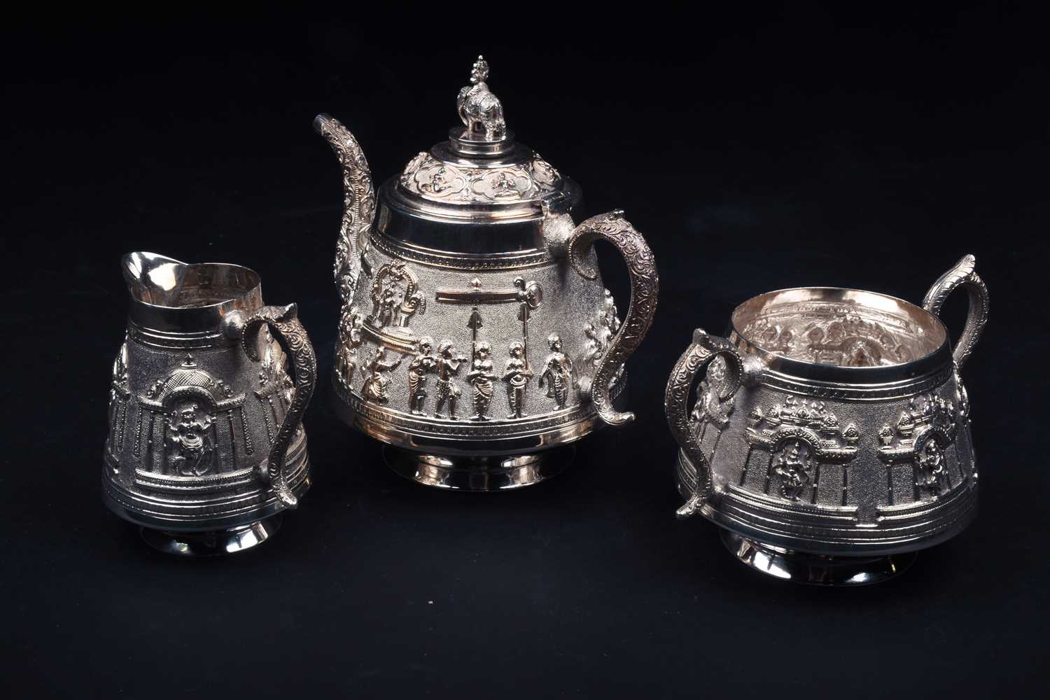 An Indian white metal three-piece teaset and conforming oval tray, 20th century, each decorated with - Image 3 of 5