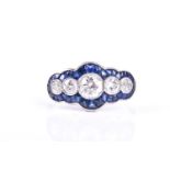 An Art Deco diamond and sapphire half hoop ring, the five graduated old brilliant cut diamonds in