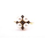 A Continental yellow metal, pearl, and diamond quatrefoil cluster ring, set with four cultured