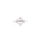 A four stone diamond ring, the mixed old cut diamond in eight claw mounts to an open circular frame,