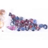 A mixed assortment of various gemstones, including garnets, citrines, pearls, turquoise, opals,