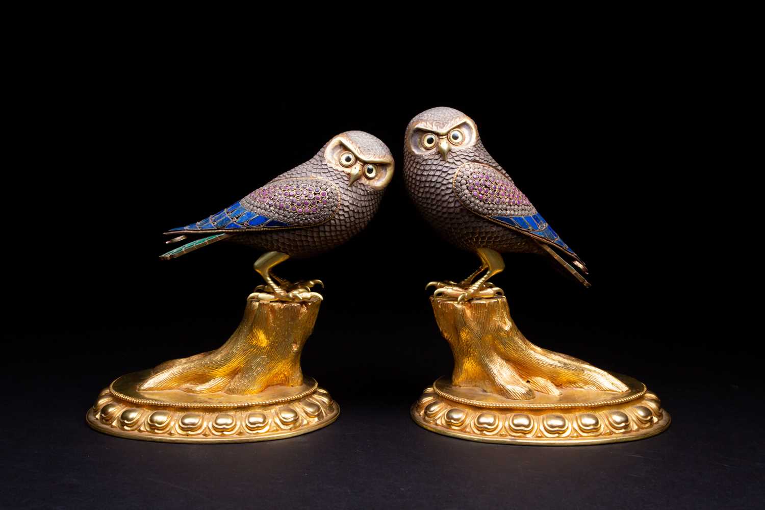 A large pair of silver and silver gilt owls, 20th century, with gilt beak and brows, one with