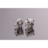 A pair of solitaire diamond earrings, the round brilliant-cut stones approximately 1.20 carats