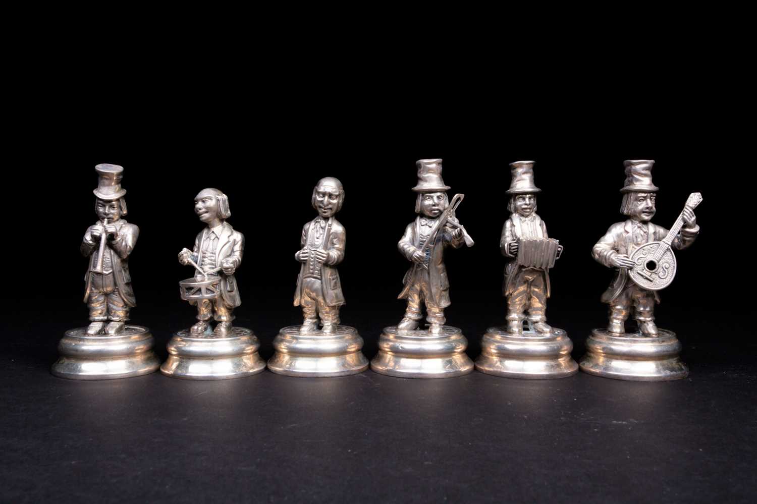 A set of six Spanish silver musician figures, 20th century, playing a variety of instruments, on