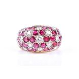 A diamond and ruby bombe style ring, the wide band set with tessilated flower head clusters of round