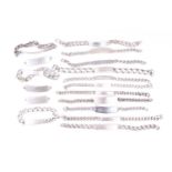 A group of various silver and base metal identity bracelets, most with flattened curb-link or Figaro