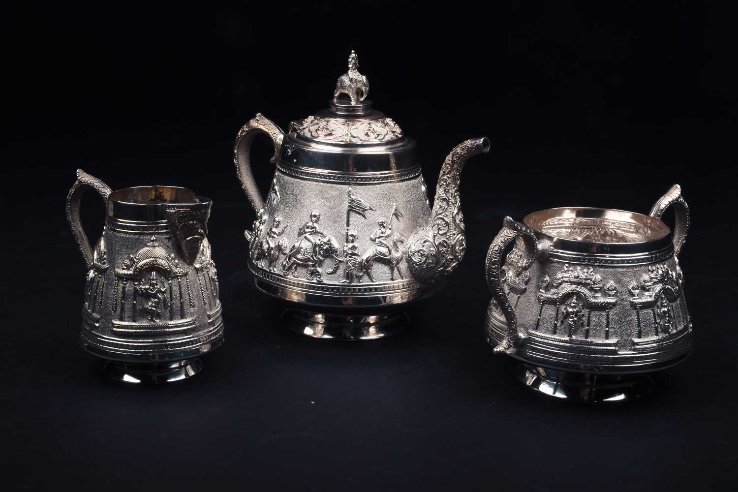 An Indian white metal three-piece teaset and conforming oval tray, 20th century, each decorated with - Image 2 of 5