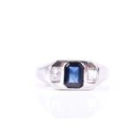 An unusual diamond and sapphire ring, set with a mixed rectangular-cut sapphire, flanked with two