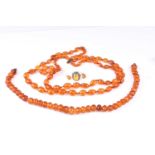 A two row faceted amber bead necklace, the slighlty graduated beads to a barrel clasp. 53cm