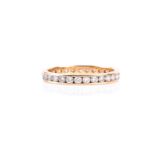 A diamond full hoop eternity ring, the round brilliant cut diamonds channel mounted in plain 18ct