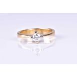 A single stone diamond ring, the round brilliant cut diamond in raised four claw mount, to