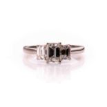 An 18ct white gold and diamond ring, set with three emerald-cut diamonds of approximately 1.0 carats