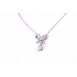 A diamond set bow pendant, the bow set with a central brilliant cut diamond and pear-shaped