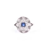 An Art Deco diamond and sapphire cluster ring, the central square, step cut sapphire in millegrain