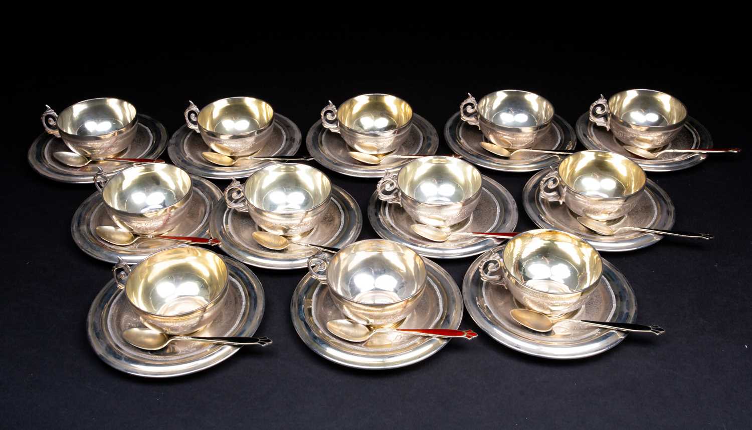 A set of twelve Syrian silver dowry cups and saucers, marked 'Silver' to the bases, together with