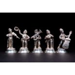 A group of five Spanish silver street musicians, circa 1960s, playing a variety of instruments, on