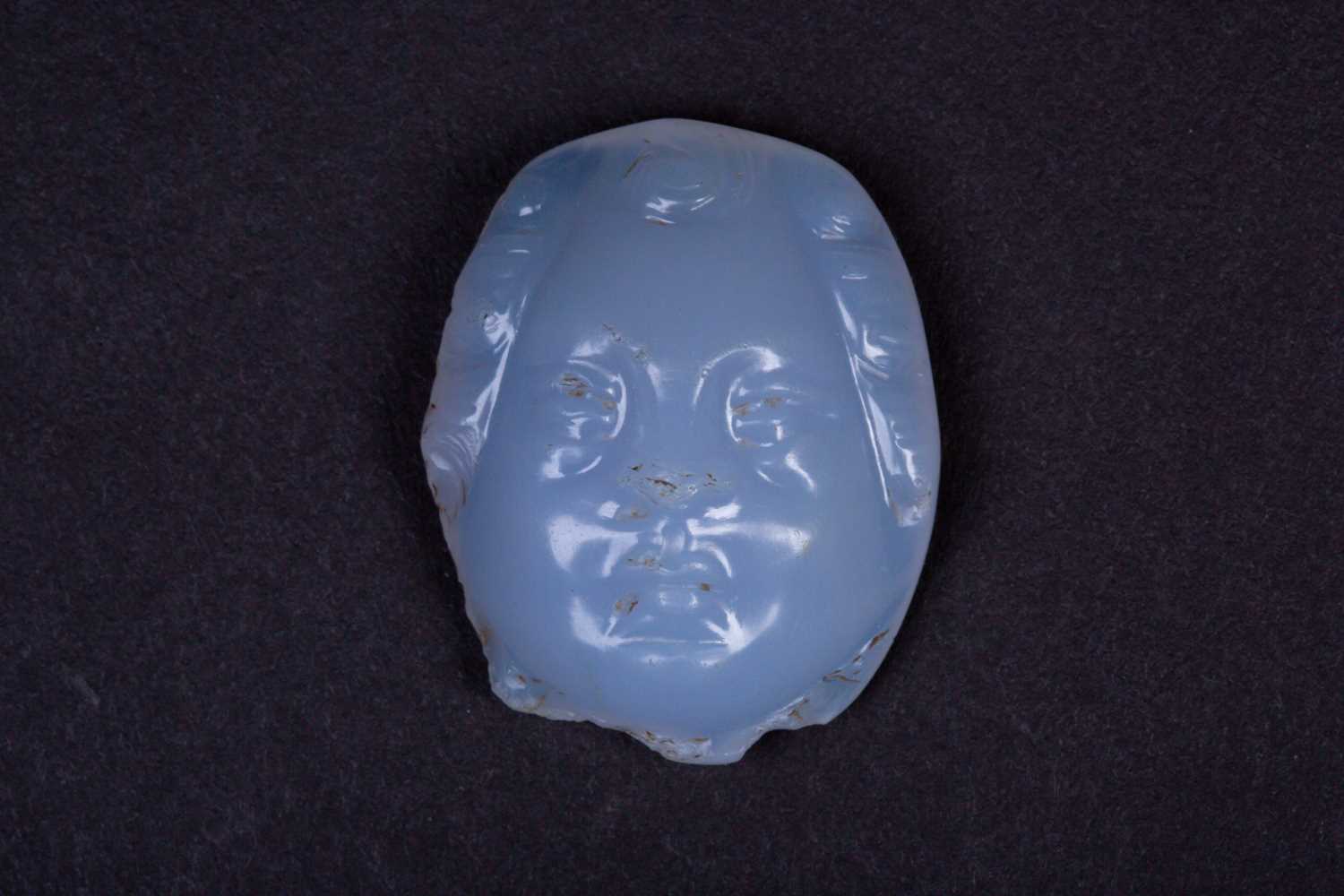 A Persian carved chalcedony cameo, the male face with curly hair, the stone a milky blue colour, 3.