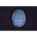 A Persian carved chalcedony cameo, the male face with curly hair, the stone a milky blue colour, 3.