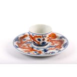 A Chinese blue and iron red dragon bowl and stand, each painted with two scaley dragons in pursuit