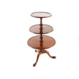 A Georgian mahogany three tier dumb waiter, the graduated circular platforms with moulded borders,