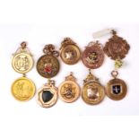 A group of ten various early 20th century 9ct yellow and rose gold medallion pendants, including