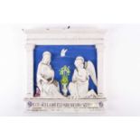 An Italian Cantagalli tin glazed wall plaque, 'The Annunciation', of rectangular form, modelled in