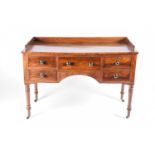 An early 19th century Scottish mahogany dressing table, with blind gallery back framing the well