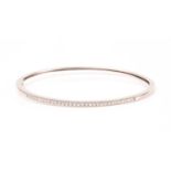 A diamond bangle, the white metal mount (marked 14K) inset with small round brilliant-cut diamonds