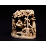A Japanese ivory okimono, Meiji period, carved as a family before a waterwheel, the attendant