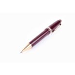 A Montblanc Meisterstuck propelling pencil, with maroon resin cap and body, and gold plated mounts.