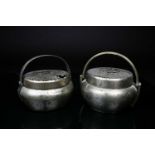 Two Chinese paktong hand warmers, Qing, late 19th/early 20th century, of circular and oval form,