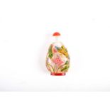 A Chinese glass and enamel snuff bottle, Qing, the clear glass body cut away and painted in