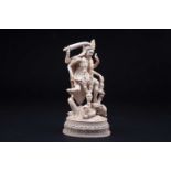 A superbly carved ivory figure of Kali, late 19th/early 20th century, the goddess holding a sword, a
