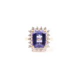 A diamond and tanzanite dress ring, set with a mixed rectangular-cut tanzanite of approximately 4.45
