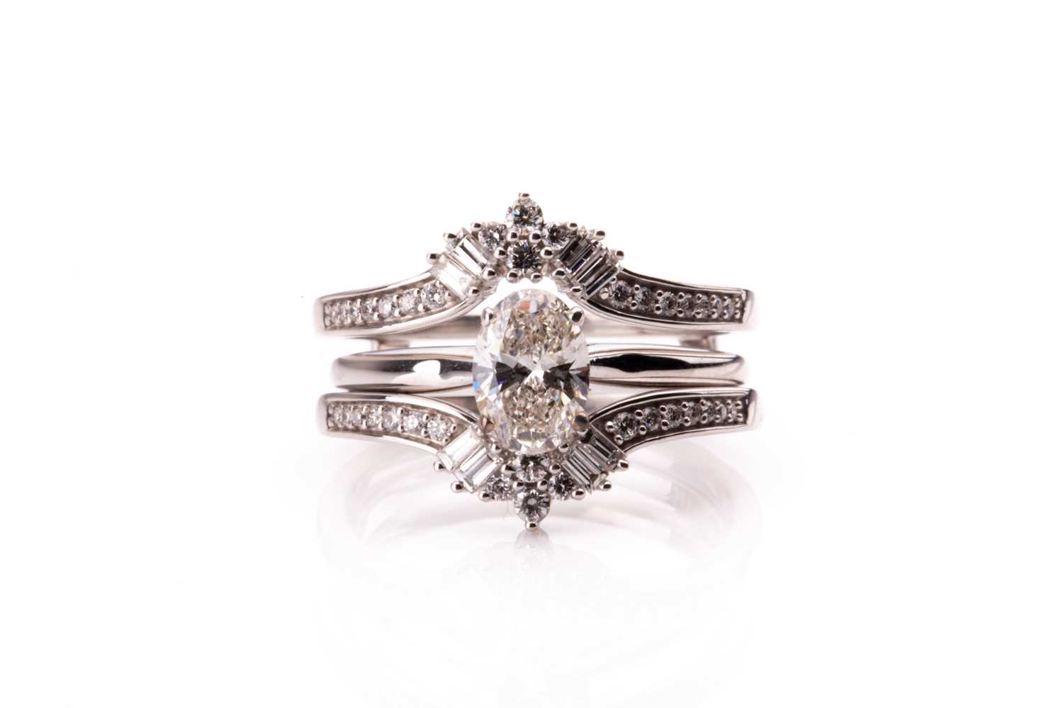 A 14ct white gold and mixed oval-cut solitaire diamond ring, the oval-cut diamond of approximately