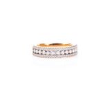 A three row diamond ring, the central band of round brilliant cut diamonds flanked with rows of