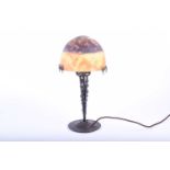 A Secessionist wrought iron table lamp with hand worked metal base, signed Pierre Maynadier, with