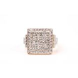 An 18ct yellow gold and diamond ring, the square-shaped mount inset with calibre-cut square